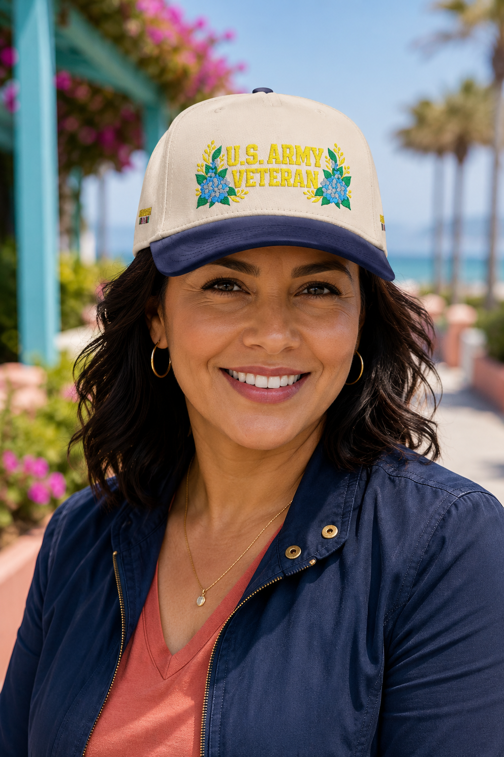 Latina woman veteran wearing the Still Her blue hydrangea U.S. Army Veteran floral hat